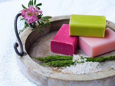 Selection of soap bars presented in a decorative wooden dish