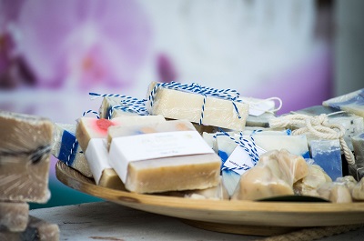 Selection of soap bars presented on a wooden plate
