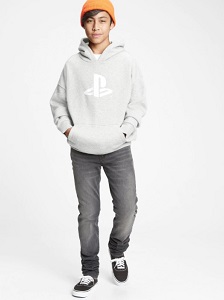 Image of a teen by model wearing an oversized graphic light grey hoodie in a 'PlayStation' Brand style print. This collection is made to help save water and reduce waste.