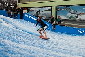 Image of a teenager trying an indoor surfing experience.