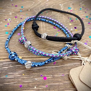 Image of a bracelet, made from recycled PET bottles. Approximately 40 bottles are used in every kilo of cord. Each bracelet has a single recyclable metal alloy bead for decoration.