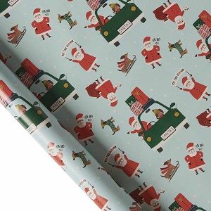 Image of recyclable Christmas wrapping paper, print is a repeated Santa in a festive holiday scene on a pale green background, to help you be more eco friendly
