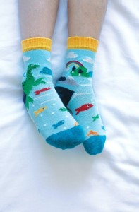 Image of children's socks with a dinosaur sea print, made with organic cotton